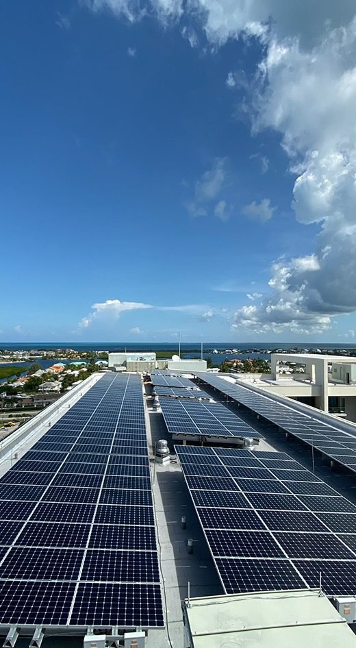 A GreenTech rooftop solar array overlooking the sea in Grand Cayman