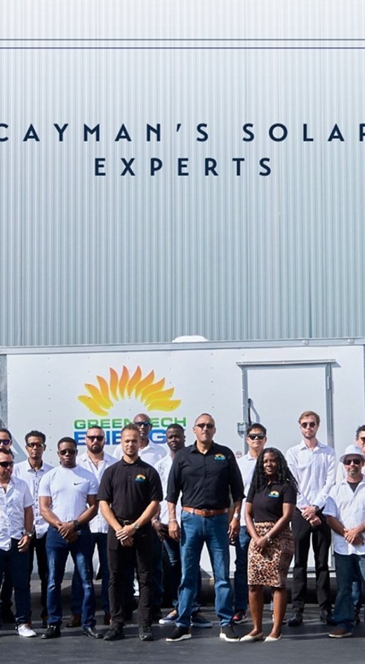 The GreenTech team standing in front of their branded trailer